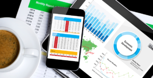 Computer and phone screen showing components of a revenue cycle dashboard