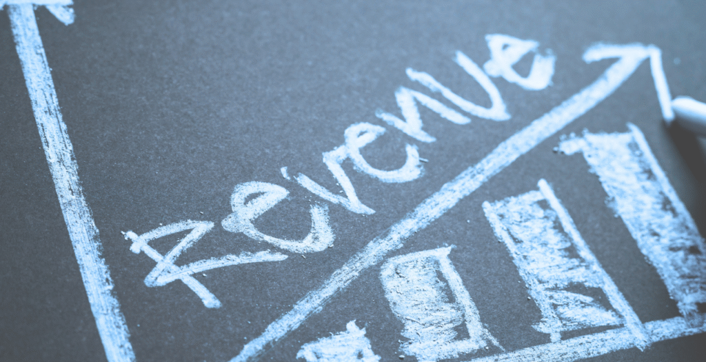 Revenue written on a chalkboard to represent outsourcing revenue cycle management