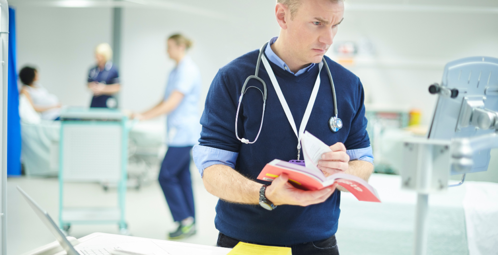 Nurse reviewing a manual to represent cms final rule 2026